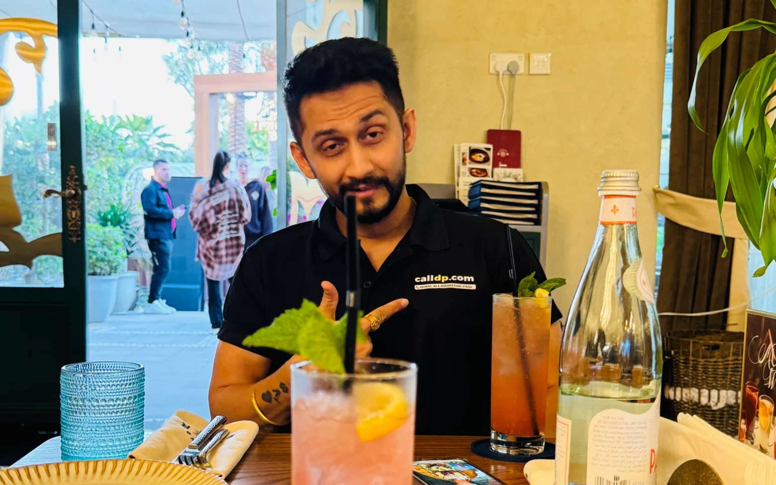 Digital Pratik talking with his hands while sitting down, mid sentence