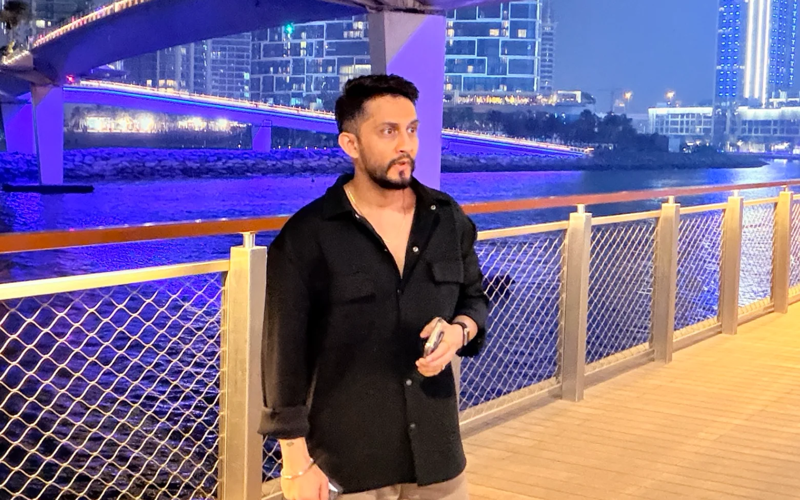Digital Pratik smiling while recording a voice note on his phone