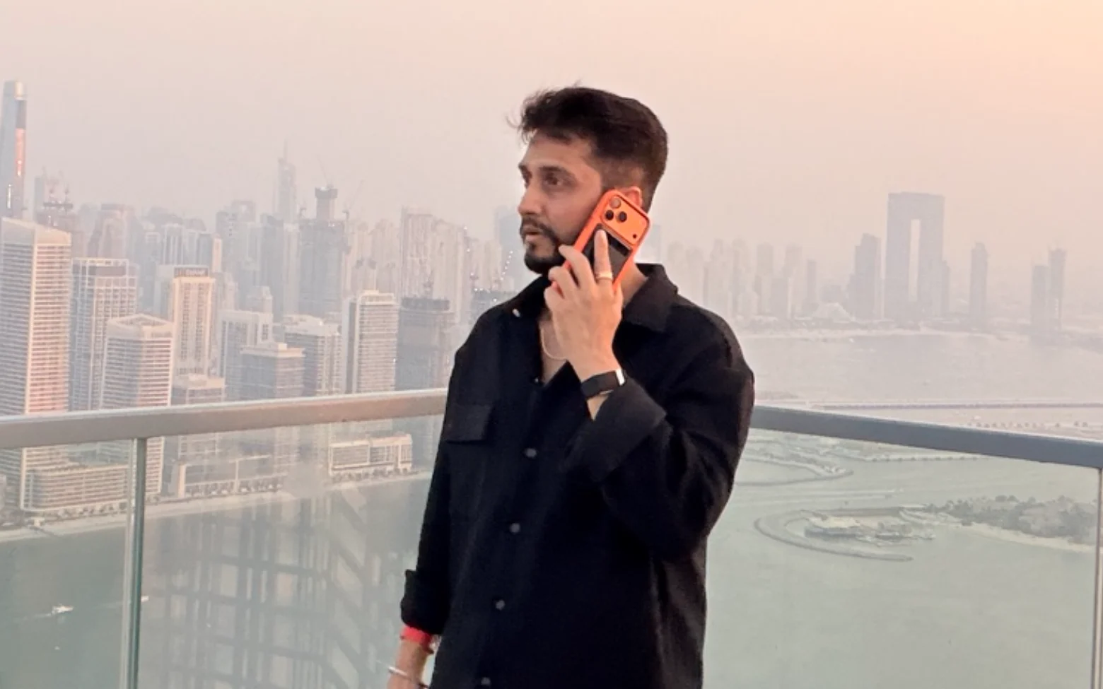 Digital Pratik talking into his phone held close to his mouth, bag on his shoulder