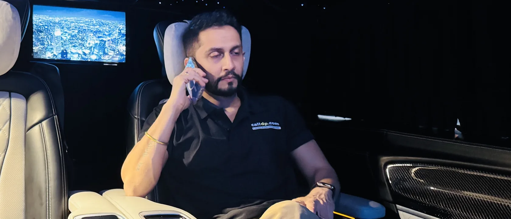 Digital Pratik on a phone call in the back of a car at night
