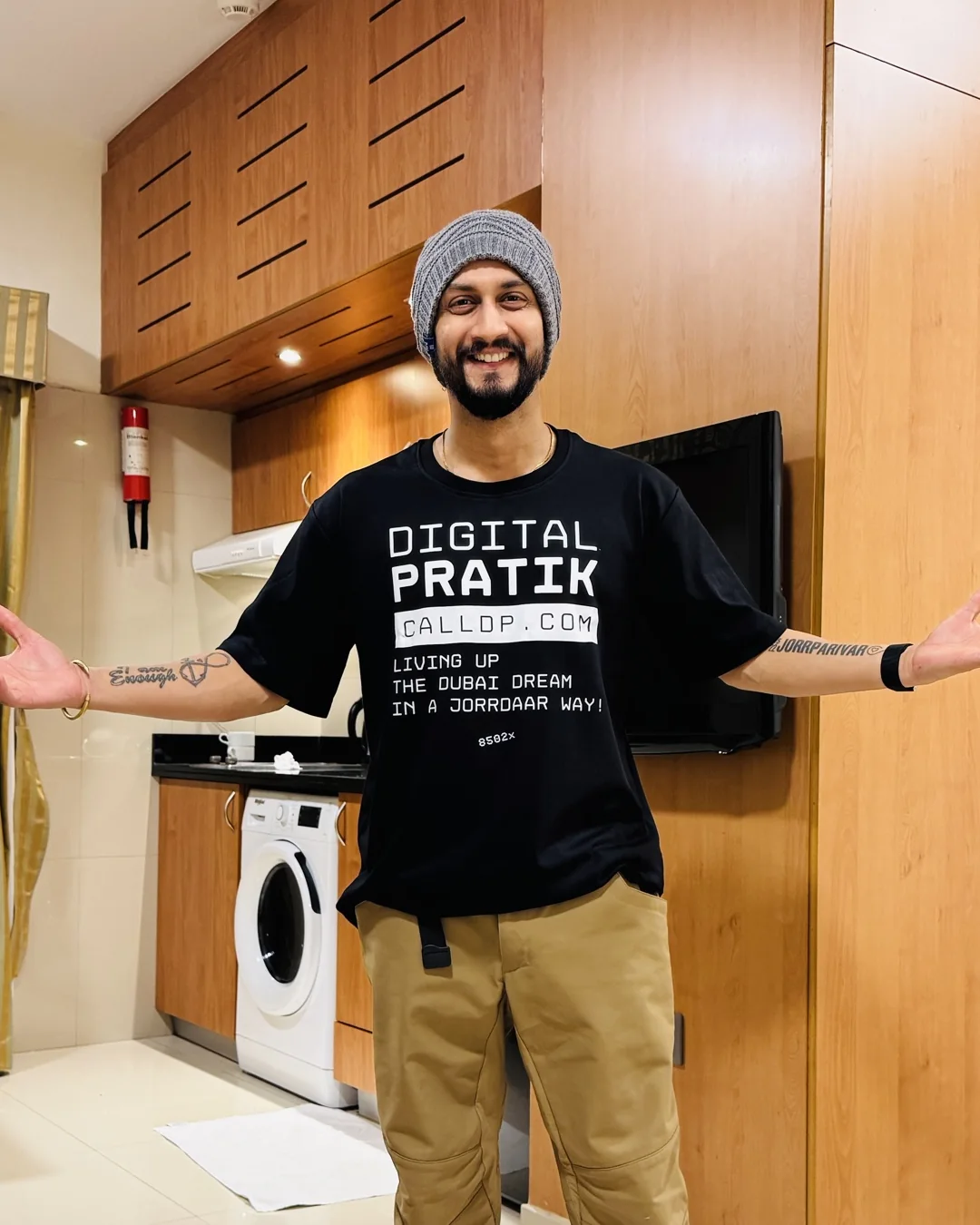 Digital Pratik with his arms open, in a Digital Pratik t-shirt