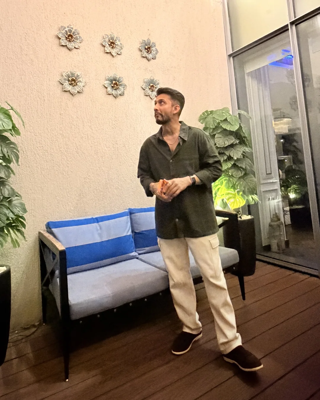 Digital Pratik talking on a terrace with plants and string lights