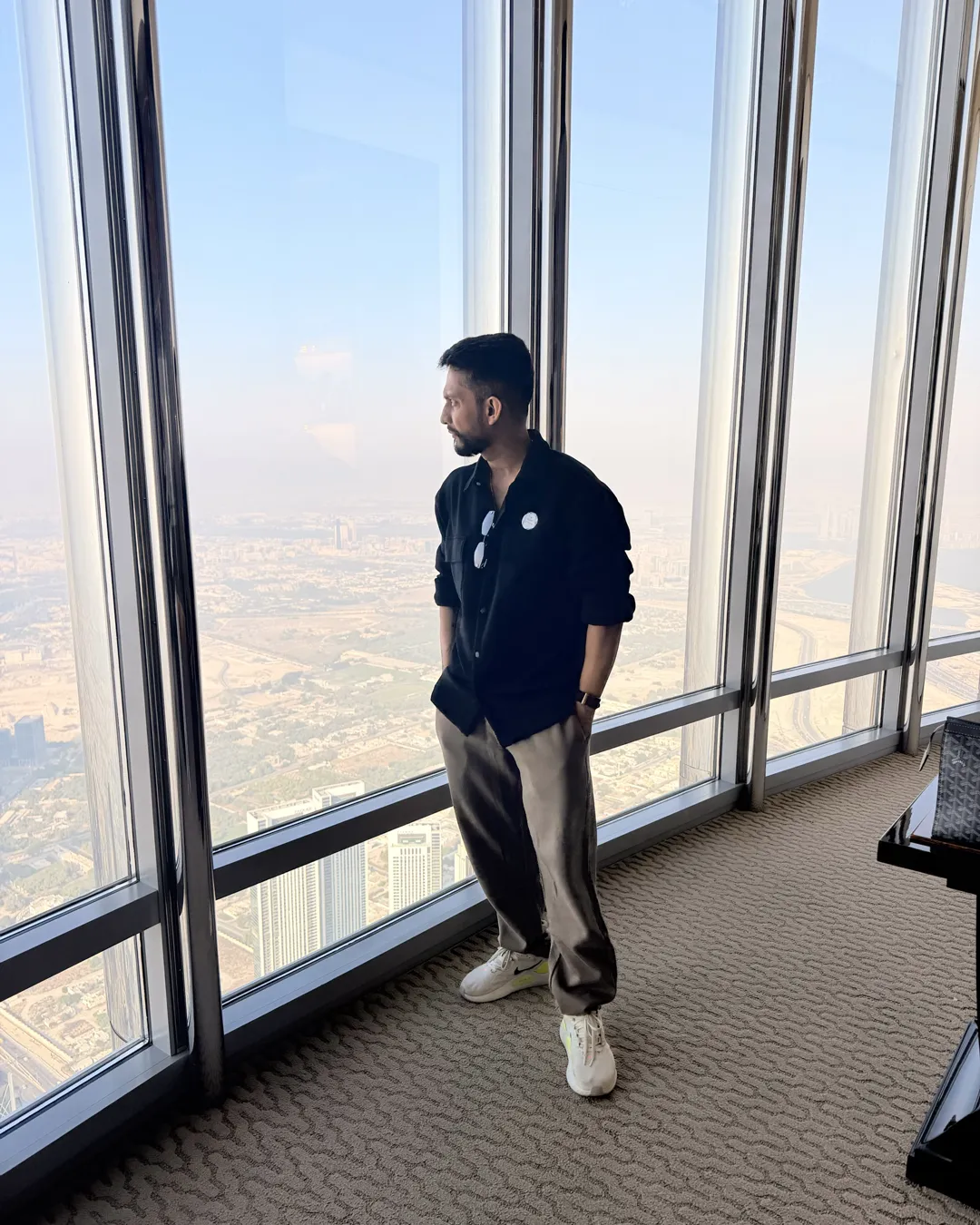 Digital Pratik looking out over Dubai from a high window